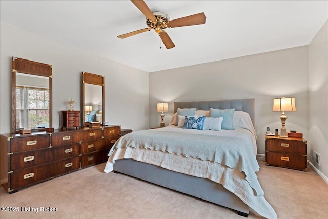 bedroom with light carpet, baseboards, visible vents, and a ceiling fan