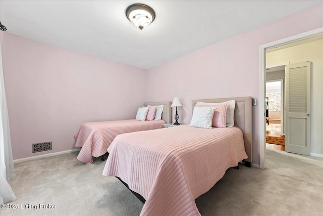 carpeted bedroom featuring visible vents and baseboards