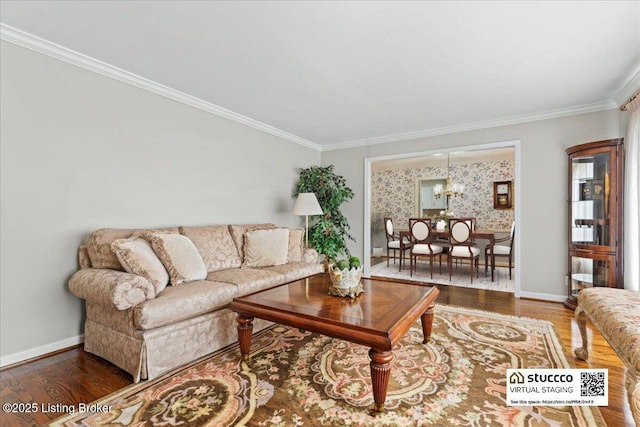 living room with an inviting chandelier, baseboards, ornamental molding, and wood finished floors