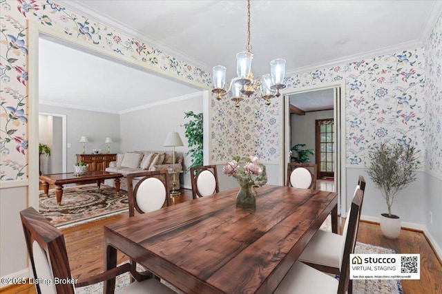 dining area featuring a chandelier, wood finished floors, crown molding, and wallpapered walls