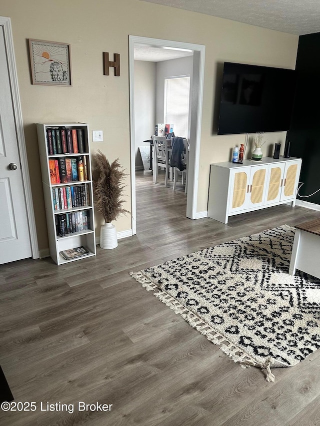 interior space featuring baseboards and wood finished floors