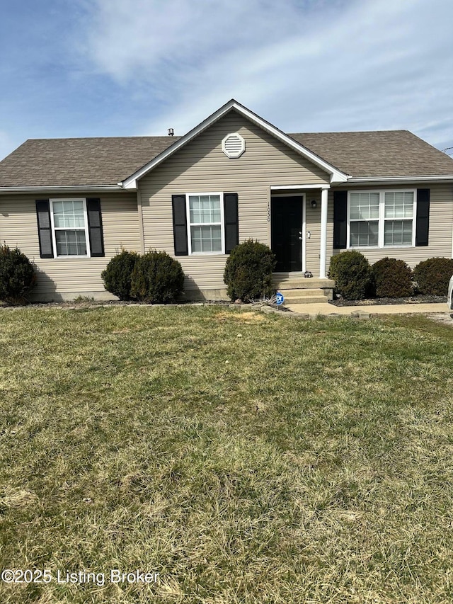 single story home featuring a front yard and roof with shingles