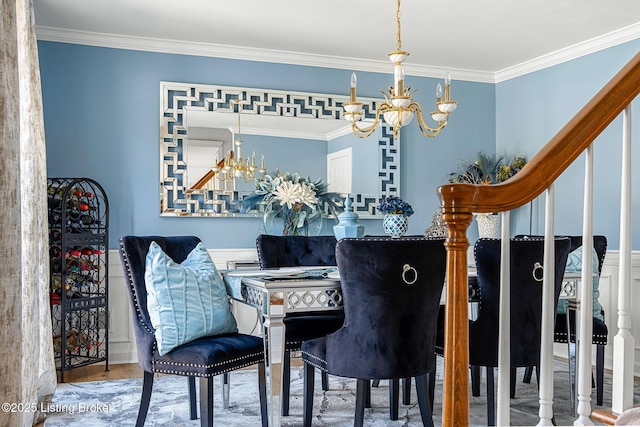 dining area featuring ornamental molding, a notable chandelier, and wood finished floors