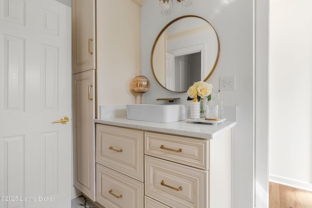 bathroom featuring vanity, baseboards, and wood finished floors