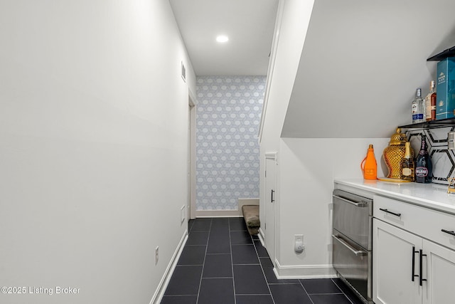 interior space featuring baseboards, tile patterned floors, visible vents, and wallpapered walls