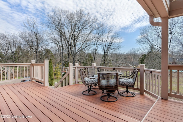 wooden deck featuring outdoor dining area