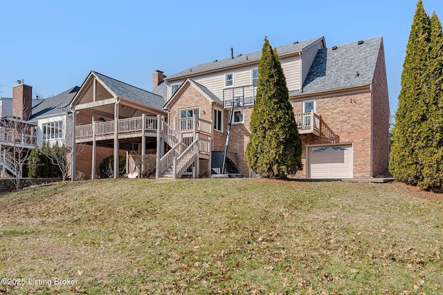 rear view of property featuring an attached garage, brick siding, stairs, a yard, and a wooden deck