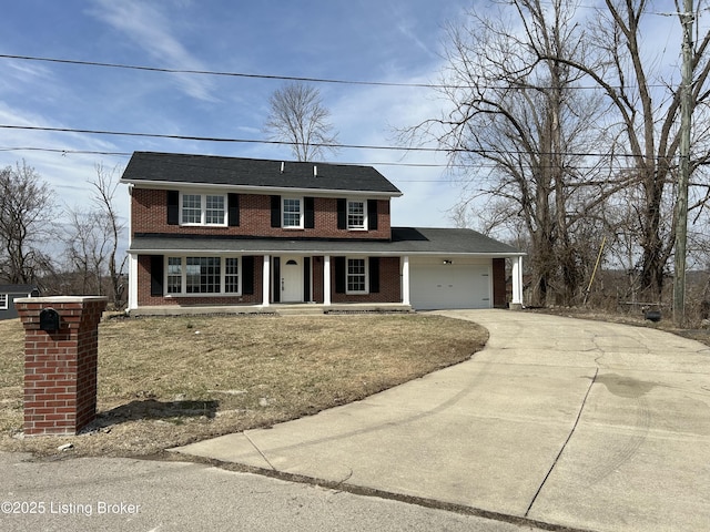 view of front of house featuring a garage, concrete driveway, covered porch, and brick siding