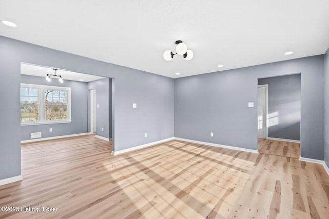 spare room with a chandelier, recessed lighting, visible vents, baseboards, and light wood finished floors