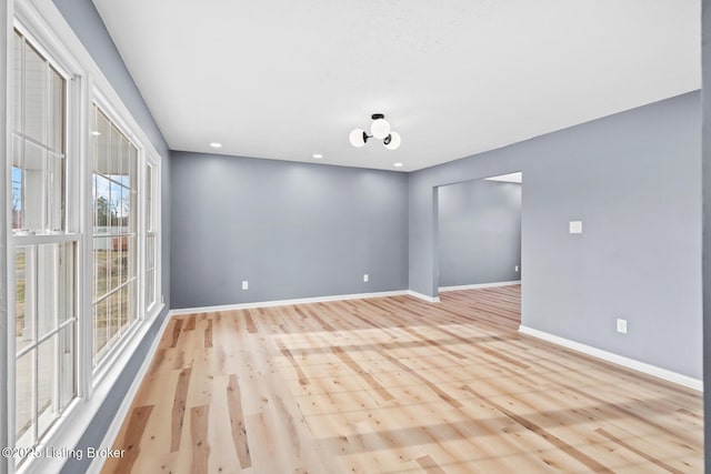 spare room with light wood finished floors, baseboards, and recessed lighting