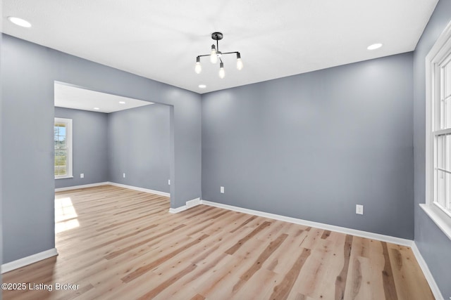 unfurnished room with recessed lighting, baseboards, and wood finished floors