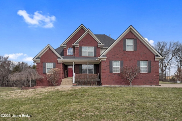 view of front facade with a front lawn, a porch, and brick siding