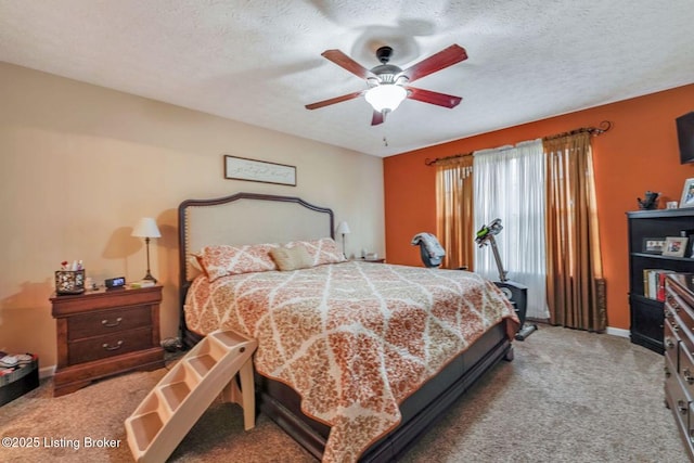 bedroom featuring light colored carpet, a ceiling fan, baseboards, and a textured ceiling