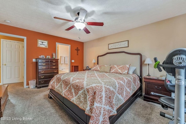 bedroom featuring a ceiling fan, baseboards, a textured ceiling, carpet flooring, and connected bathroom