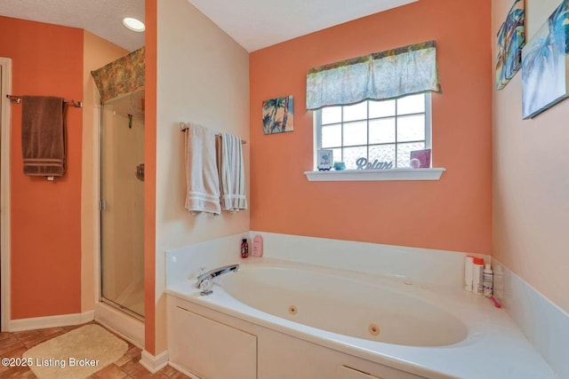 full bath featuring tile patterned flooring, a shower stall, a jetted tub, and baseboards