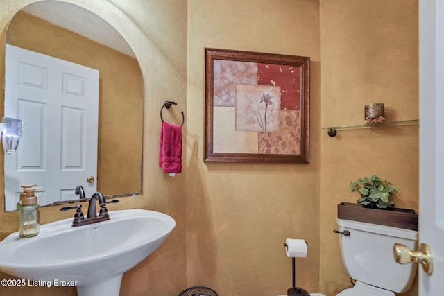 bathroom with toilet and a sink