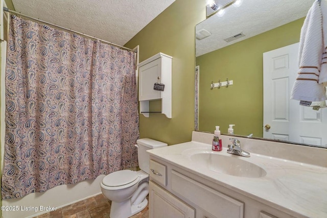 bathroom featuring visible vents, toilet, a textured ceiling, and vanity