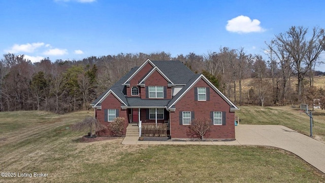 view of front facade featuring brick siding, a porch, and a front lawn