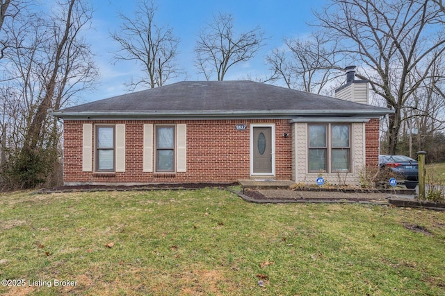 view of front of home featuring a shingled roof, a chimney, a front lawn, and brick siding