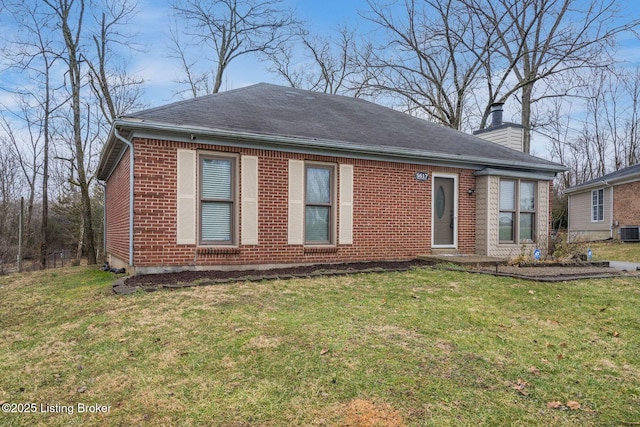 view of front of home featuring brick siding, a shingled roof, a chimney, central air condition unit, and a front yard