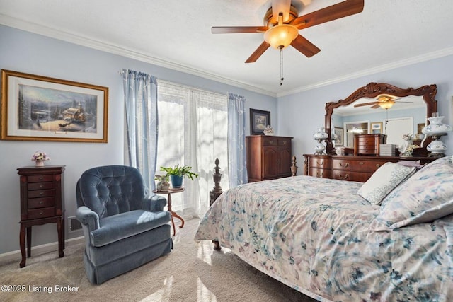 carpeted bedroom with a ceiling fan, crown molding, and baseboards