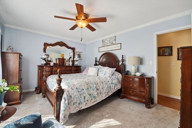 bedroom featuring ceiling fan, baseboards, crown molding, and carpet flooring