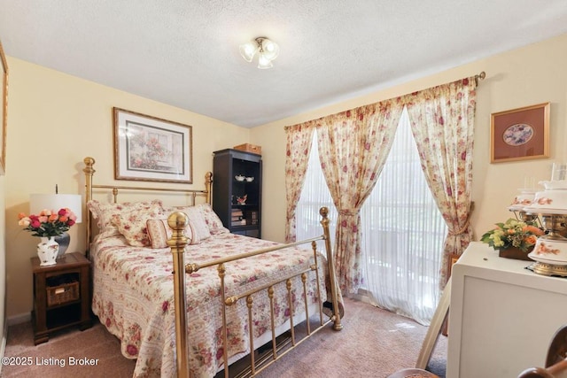 carpeted bedroom featuring access to outside and a textured ceiling