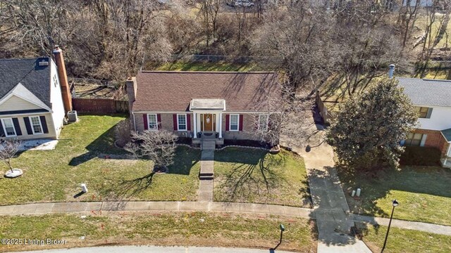 view of front of house with a front yard and fence