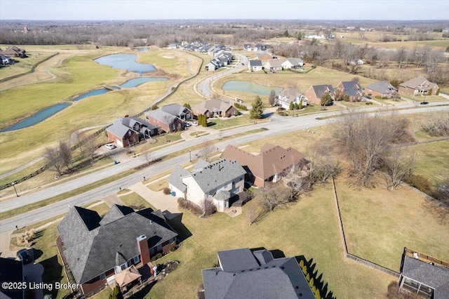 drone / aerial view with a water view, view of golf course, and a residential view