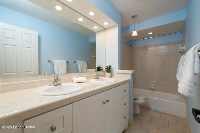 full bath featuring double vanity, shower / tub combination, a sink, and tile patterned floors