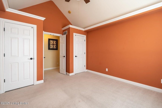 unfurnished bedroom featuring visible vents, a ceiling fan, light carpet, vaulted ceiling, and baseboards