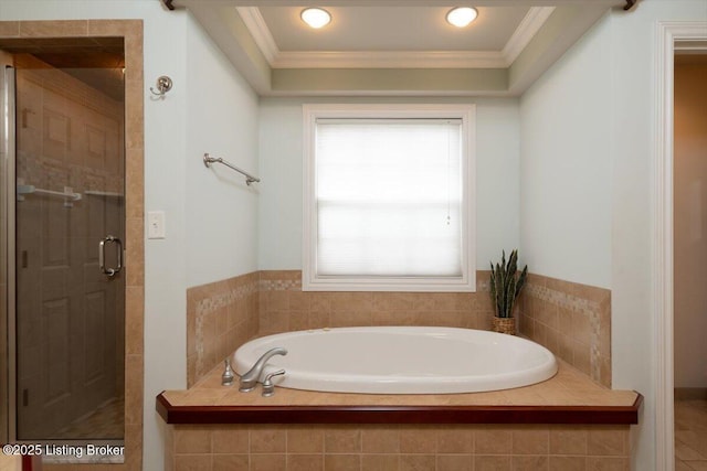 full bathroom featuring a bath, a stall shower, and crown molding