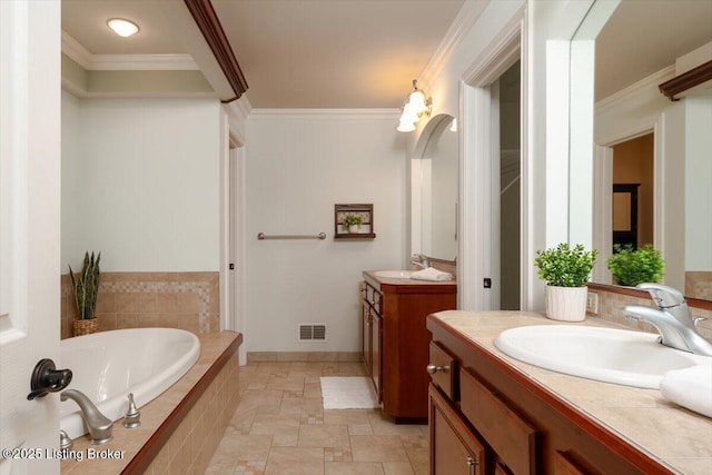 bathroom with visible vents, two vanities, a sink, and ornamental molding