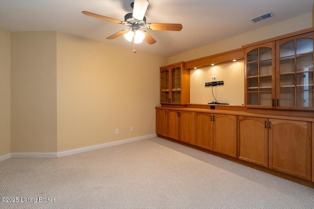 unfurnished room with light carpet, ceiling fan, visible vents, and baseboards