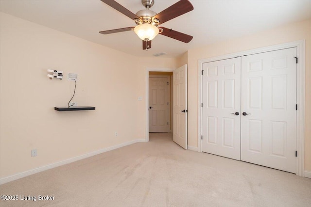 unfurnished bedroom with a closet, visible vents, a ceiling fan, light carpet, and baseboards