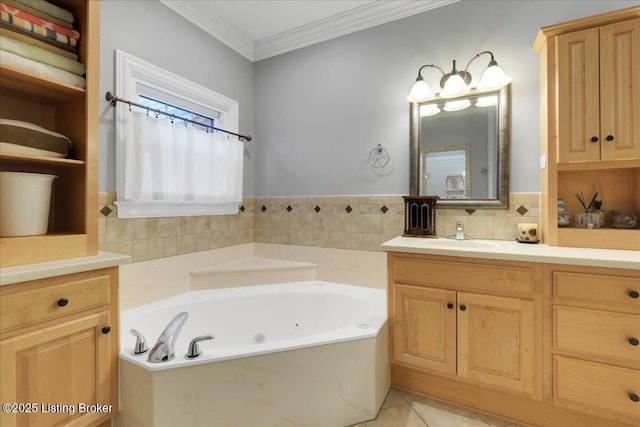 bathroom with a tub with jets, ornamental molding, vanity, and tile patterned floors