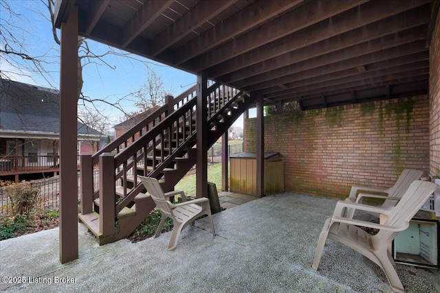 view of patio featuring a hot tub and stairs