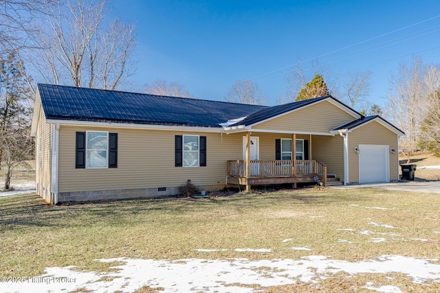 single story home with metal roof, a porch, an attached garage, and a front yard