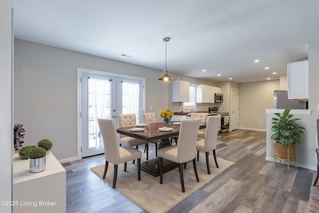 dining room featuring recessed lighting, french doors, light wood-style flooring, and baseboards