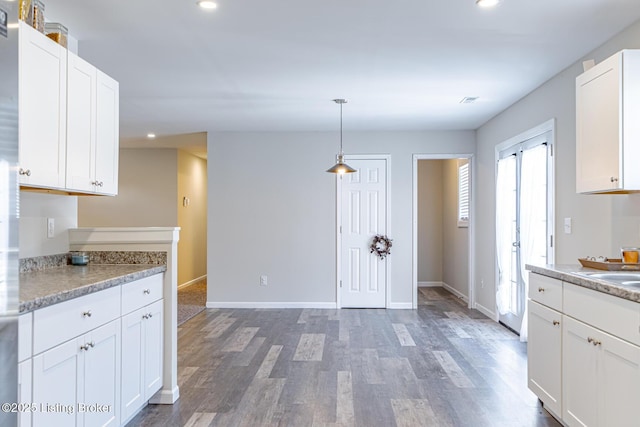 kitchen featuring white cabinetry, light countertops, wood finished floors, and recessed lighting