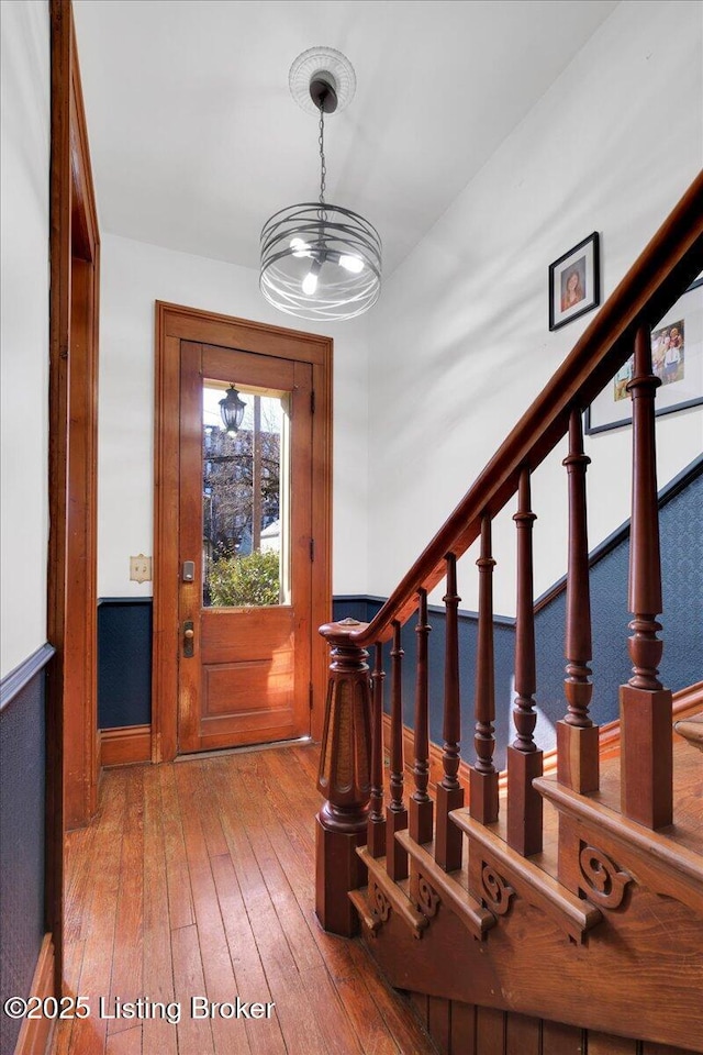 entrance foyer with wood-type flooring and stairs