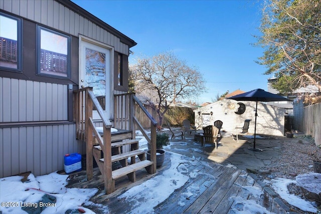 snow covered deck with fence private yard