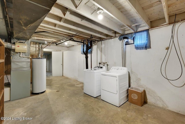 below grade area featuring water heater and washing machine and clothes dryer