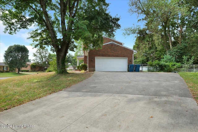 view of front facade featuring driveway, brick siding, a front lawn, and an attached garage