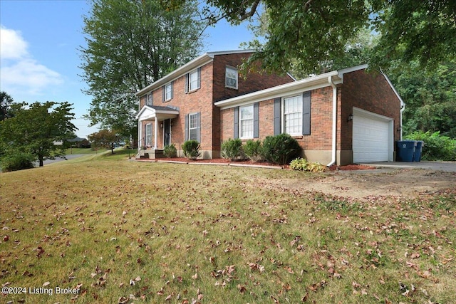 view of front of home with brick siding, an attached garage, driveway, and a front lawn