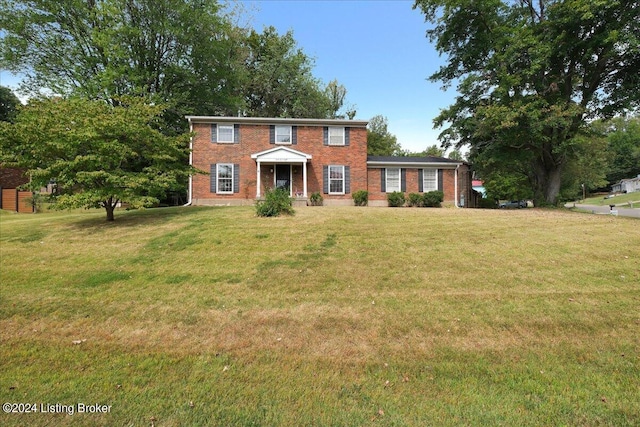 colonial house with brick siding and a front lawn