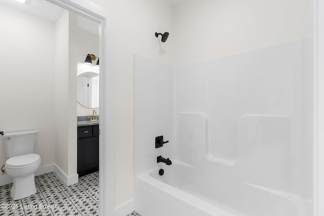 full bath with bathing tub / shower combination, vanity, toilet, and baseboards