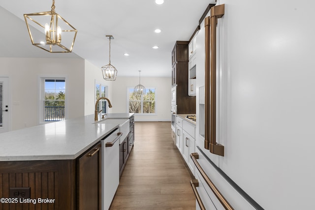 kitchen with a chandelier, white appliances, dark wood-style flooring, and recessed lighting