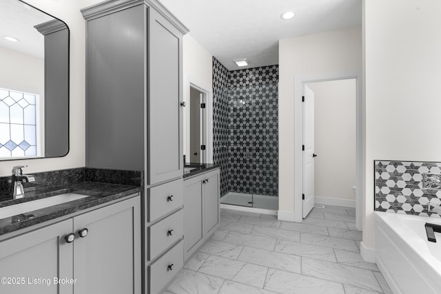 full bath featuring marble finish floor, vanity, a textured ceiling, and a stall shower