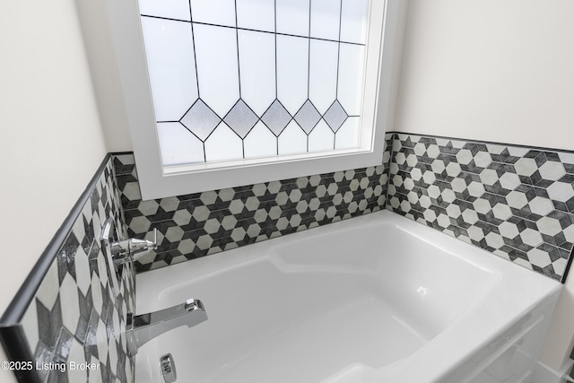 full bathroom featuring a healthy amount of sunlight and a garden tub